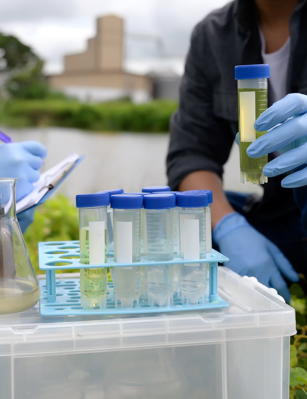 Two Environmental Engineers Inspect Water Quality and Take Water Two Environmental Engineers Inspect Water Quality and Take Water sample notes in The Field Near Farmland, Natural Water Sources maybe Contaminated by Toxic Waste or Suspicious Pollution Sites.